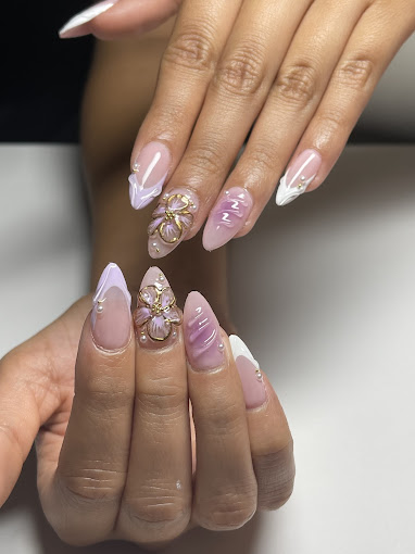 A woman's hands with pink and white nail polish