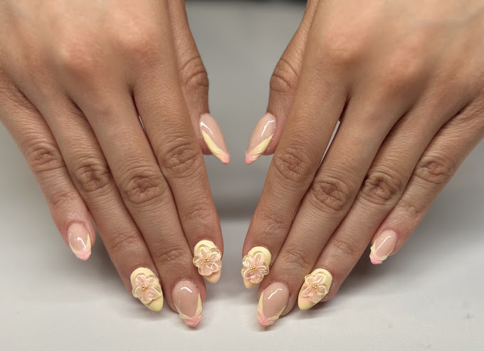 A woman's hands with french manies with flowers on them